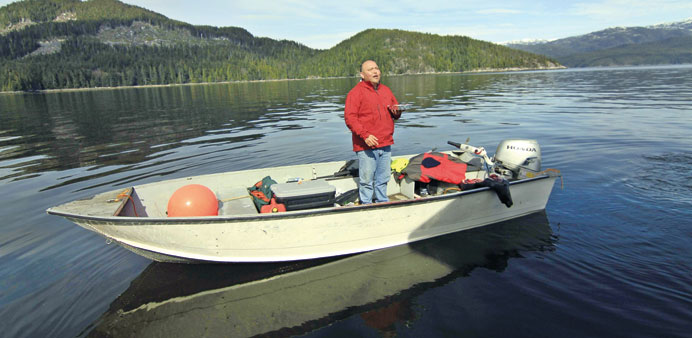 Trevor Amos stands in his fishing boat with a freshly killed seal on the Douglas Channel, in northern British Columbia near to where Enbridge Inc plan