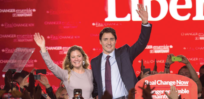 Canadian Liberal Party leader Justin Trudeau and his wife Sophie wave on stage in Montreal yesterday after winning the general elections.