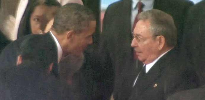 Obama shakes hands with Castro in this still image taken from video courtesy of the South Africa Broadcasting Corporation.