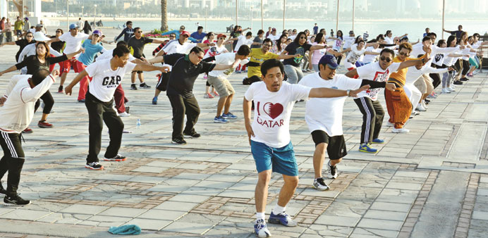 People taking part in a mass exercise on the Corniche.