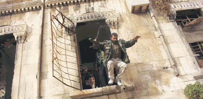 A Free Syrian Army fighter jumps from a high window during clashes with pro-government forces in Aleppou2019s Bab al-Hadid district on Thursday.