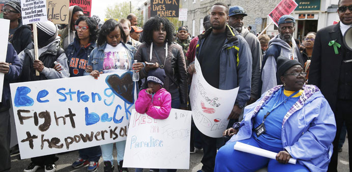 Demonstrators march through Baltimore yesterday to protest the death of Freddie Gray who died following an arrest.
