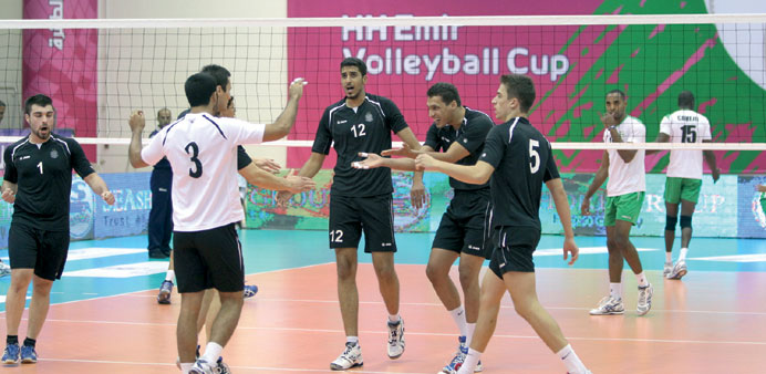 Al Saad players (in black) celebrate a point during their match against Al Ahli in the Emir Cup volleyball tournament yesterday.
