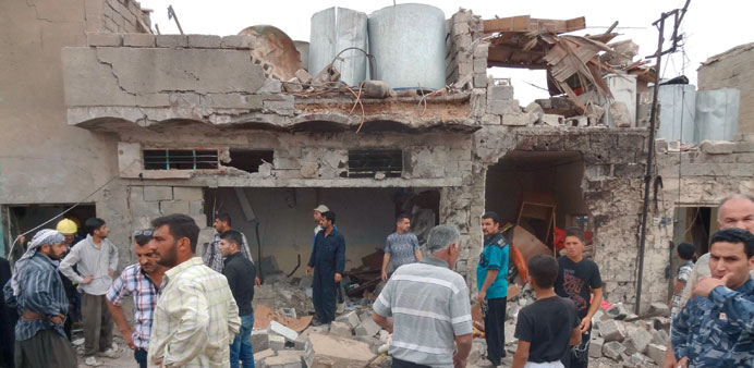 People gather at the site of a car bomb attack in Kirkuk yesterday.