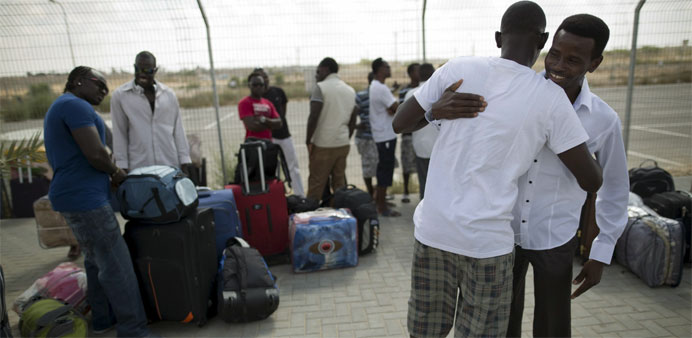 African migrants embrace after being released from Holot detention centre in Israel's southern Negev desert
