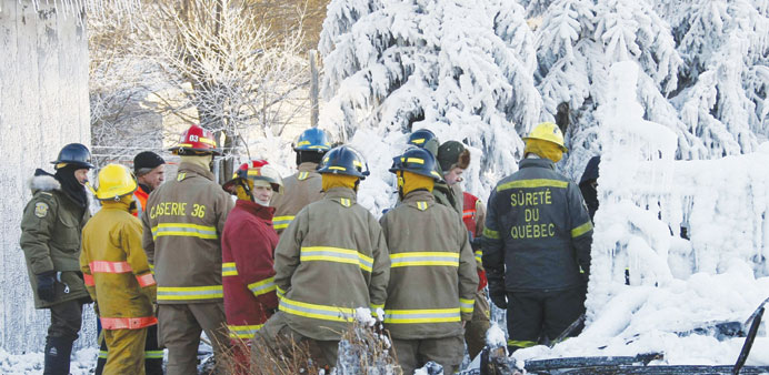 Emergency workers inspect the site of the fire at the Residence du Havre in Lu2019Isle Verte, Quebec.