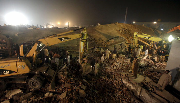Rescue workers search for survivors after a factory collapsed near the eastern city of Lahore.