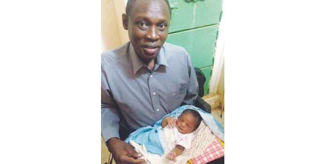    A picture taken on Wednesday, and released by the family yesterday, shows Daniel Wani carrying his newborn daughter Maya at the womenu2019s prison in O