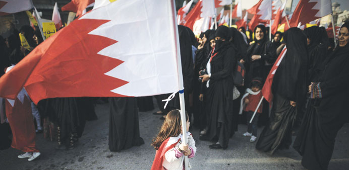  A girl waves her national flag at a demonstration near Manama.