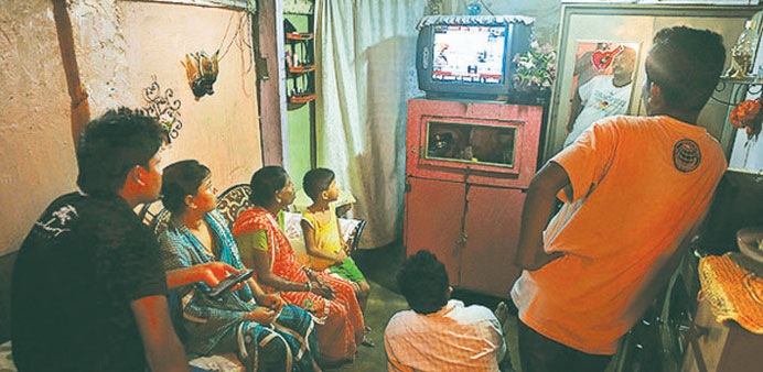 A family gathers to watch television in their home in Guwahati, India. Zindagi TV, (not pictured), recently became the first Indian station to broadca