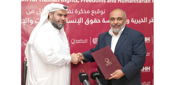    QC chief executive officer Yousef bin Ahmad al-Kuwari and IHH president Fahmi Bulent Yeldrim shake hands after signing the MoU. PICTURE: Noushad Th