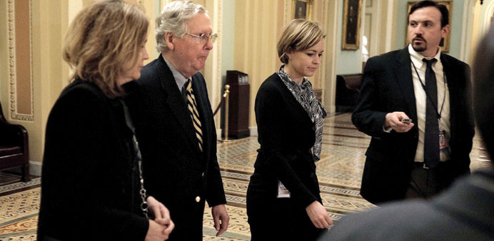 Senate Majority Leader Mitch McConnell, second from left, is quiet as he leaves the Senate chambers after passing a new stopgap funding bill for the D