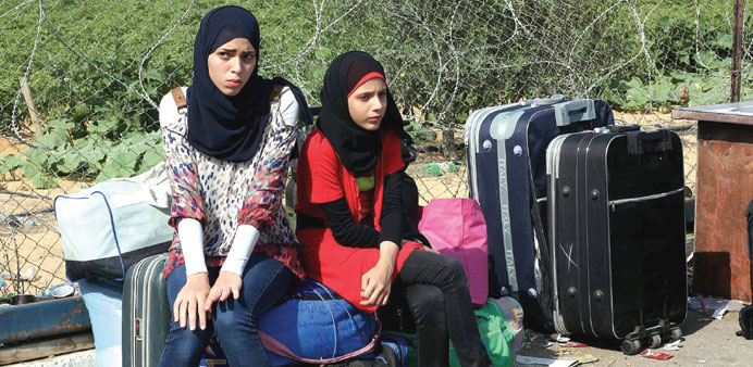 Palestinians wait to cross into Egypt at the Rafah crossing yesterday.