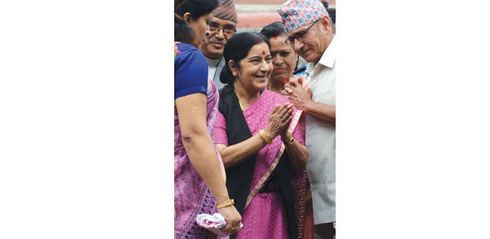 Indian Foreign Minister Sushma Swaraj, centre, gesturing as she left for India in Kathmandu yesterday.