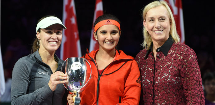 Martina Hingis (L) of Switzerland and Sania Mirza (C) of India pose with the trophy with US tennis legend Martina Navratilova (R) 