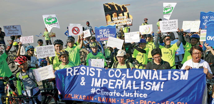 Filipino activists hold placards as they take part in a protest about climate change in Manila yesterday.