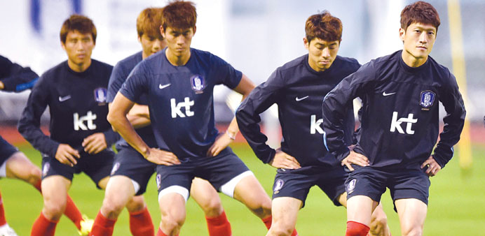 South Koreau2019s midfielder Lee Chung-Yong (right) warms up with team-mates during a training session in Foz do Iguacu, Brazil. (AFP)