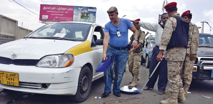 An expert uses an explosives detector as he checks vehicles at a checkpoint amid fears of Al Qaeda car bomb attacks in Sanaa yesterday.