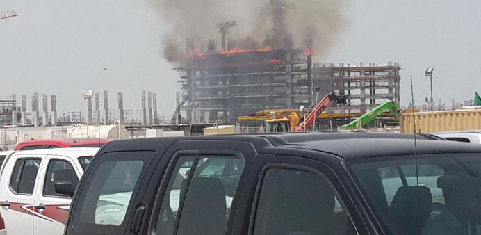 Flames and smoke seen in the under construction building yesterday. PICTURE: Yahya AbuYousef via Twitter.