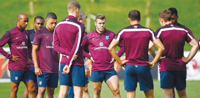 Englandu2019s Jack Wilshere (centre) chews gum during a training session at the St Georgeu2019s Park training complex near Burton-upon-Trent, central England.