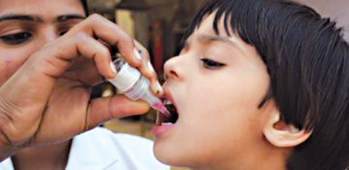 A girl being administered anti-polio vaccination in Pakistan.