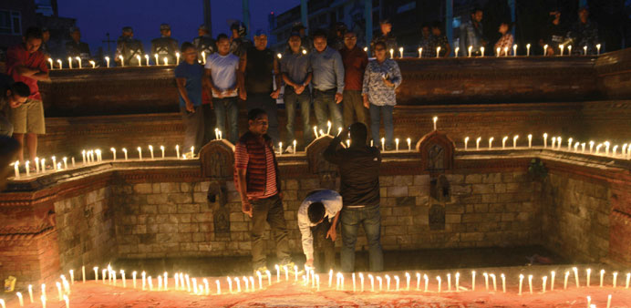 Nepalese youths light candles during an event to celebrate Nepalu2019s new national constitution in Kathmandu.