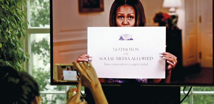 A video of First Lady Michelle Obama getting rid of old signs prohibiting photography is shown at White House.