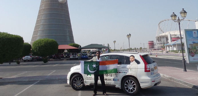 SHINING STAR: Malik in Doha with his Indo-Pak friendship flag.