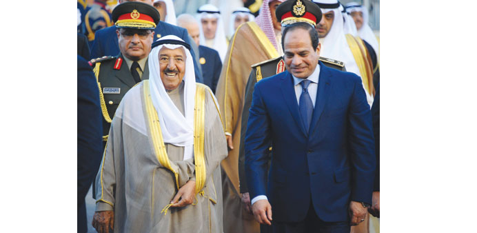 Egyptian President Abdel Fattah al-Sisi walks alongside Kuwaiti Emir Sheikh Sabah al-Ahmed al-Sabah upon the latteru2019s arrival in Sharm El Sheikh yeste