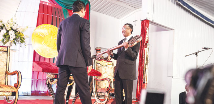 Rajaonarimampianina (right) receives the key symbolising the transfer of power from outgoing president Rajoelina during a handover ceremony at Iavoloh