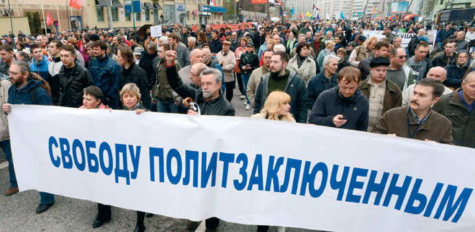 Russian opposition supporters take part in a rally in Moscow yesterday in memory of a bloody protest one year ago.