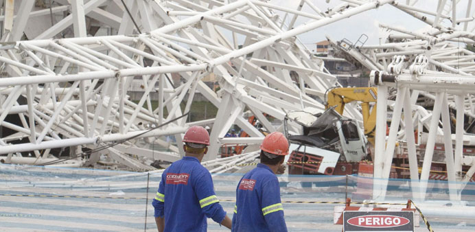 A group of workers arrive to restart the construction of Arena Corinthians stadium in Sao Paulo, Brazil, yesterday.