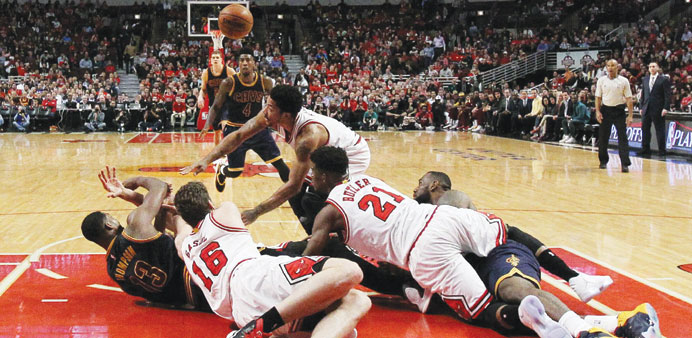 Derrick Rose, Jimmy Butler and Pau Gasol 16 of the Chicago Bulls vie for a loose ball with Tristan Thompson of the Cleveland Cavaliers in the third qu