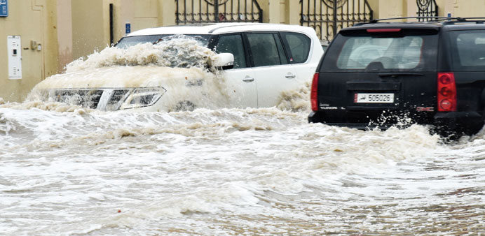 Vehicles wading through a heavily flooded street in Doha. PICTURE: Noushad Thekkayil