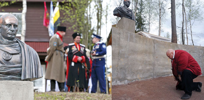 A man bows during the inauguration of a sculpture of Putin in the village of Agalatovo, about 30km from Saint Petersburg.