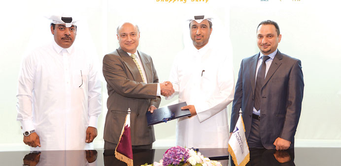 Officials of Doha Bank and Al Jaber Watches at the signing ceremony.
