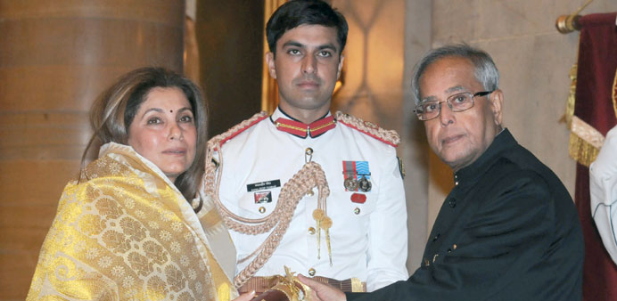 Bollywood actress Dimple Kapadia receives from President Pranab Mukherjee the Padma Bhushan award given posthumously to her husband actor Rajesh Khann