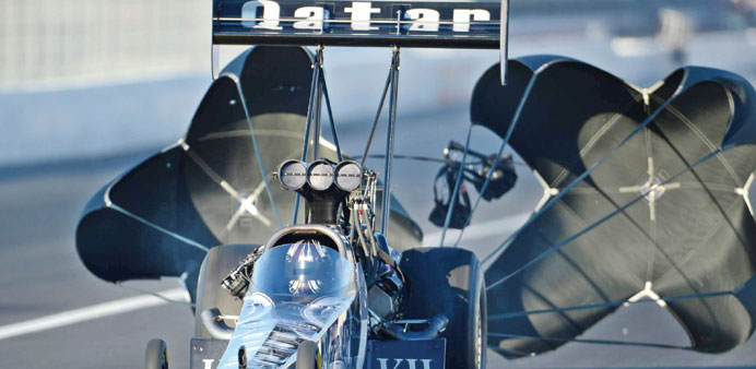 Qatar Al-Anabi Racing Top Fuel driver Shawn Langdon deploys the parachutes to slow his dragster following a qualifying run on Friday in Pomona, Califo