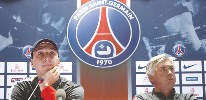  Paris Saint-Germainu2019s Zlatan Ibrahimovic of Sweden looks on next to head coach Carlo Ancelotti (R) during a news conference at the Aspire Academy of 