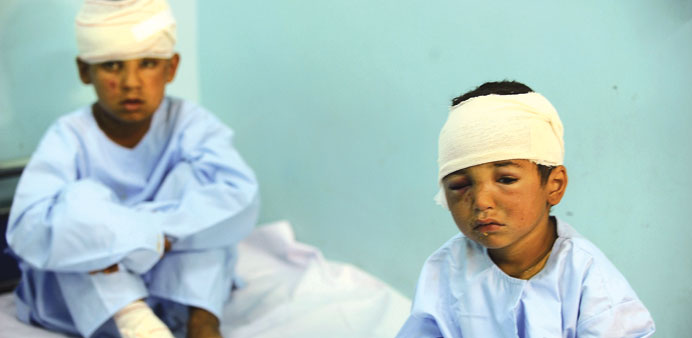 In this photograph taken on April 4, 2013, wounded Afghan children receive treatment at a local hospital after a Taliban attack in Farah province.