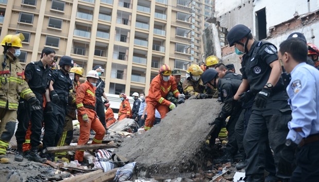 Rescue workers search at the site where residential buildings collapsed in Wenzhou, Zhejiang province, China