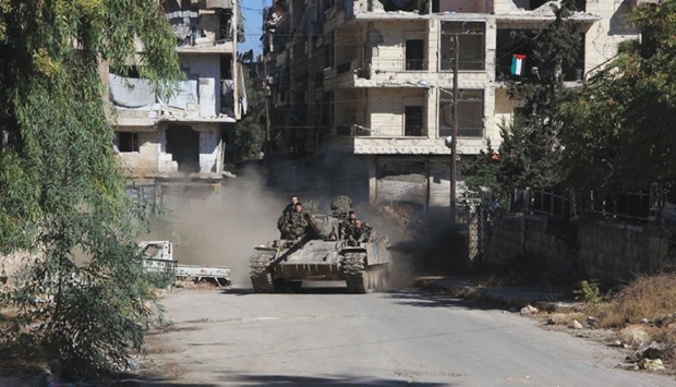 Syrian pro-government forces take part in an operation to take control of Aleppou2019s Suleiman al-Halabi neighbourhood, which is divided by the frontline that separates the rebel-held east and regime-held west of the northern city yesterday.
