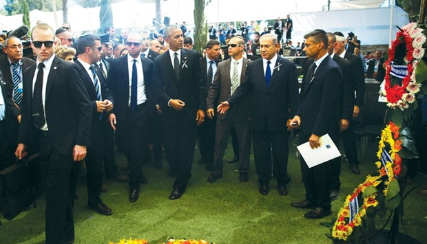 US President Barack Obama and Israeli Prime Minister Benjamin Netanyahu stand next to wreaths at the grave of former Israeli President Shimon Peres during the burial ceremony at the funeral at Mount Herzl National Cemetery in Jerusalem yesterday.