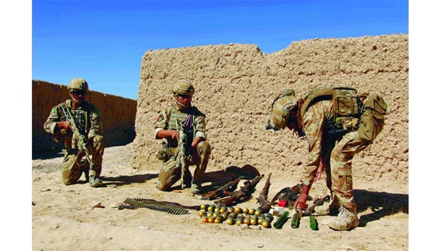 Afghan National Army commandos take position during an ongoing battle between Taliban militants and Afghan security forces in Helmand province yesterday.