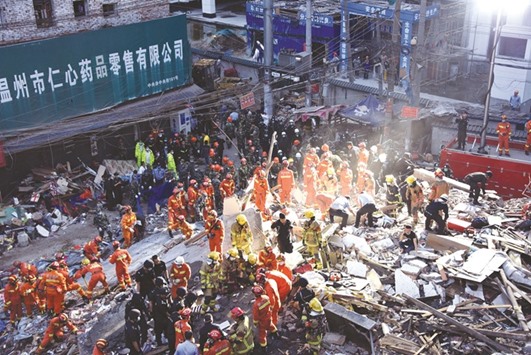 Rescuers search for survivors at the site of the building collapse in Wenzhou.