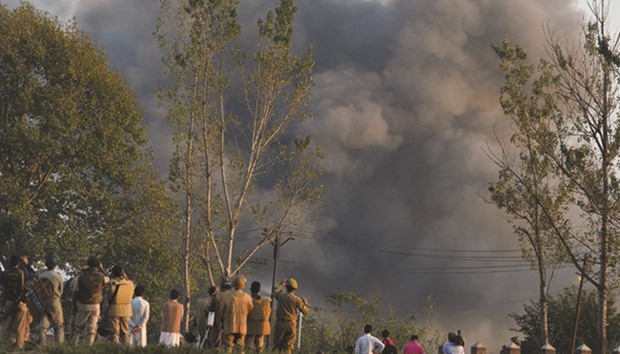 Smoke rises after the army blew up a landmine during a gunfight between soldiers and suspected militants in the Pampore area south of Srinagar yesterday.