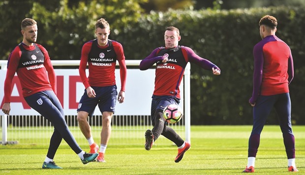 Englandu2019s Wayne Rooney (second right), Jordan Henderson (left) and Jamie Vardy at a training session in Enfield, north London, yesterday. (AFP)