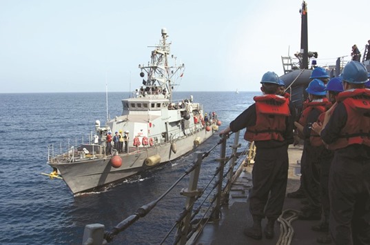 A file image released by the US Navy shows a Cyclone-class patrol craft USS Tempest (PC 2) coming alongside to perform a replenishment-at-sea through rafting with the guided-missile destroyer USS Mason (DDG 87). Two missiles fired from rebel-held territory in Yemen fell short of a US warship patrolling the Red Sea off the coast of the war-torn country, the US navy said yesterday.
