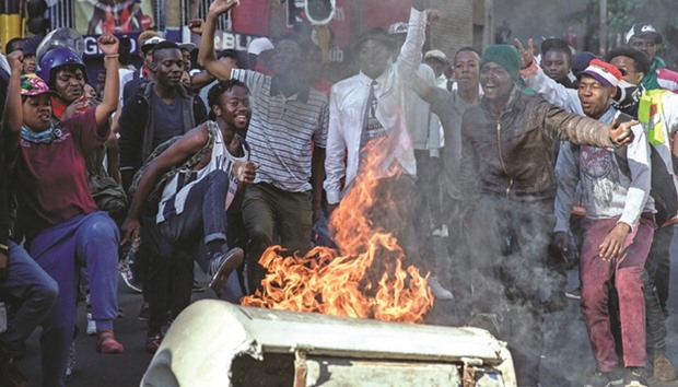 Students set fire to a garbage container at the University of Witwatersrand in downtown Johannesburg yesterday.