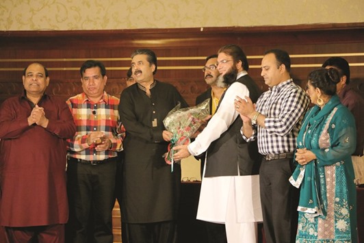 WELCOME: Shahzad Ahmad Mughal (third from right), CEO, Dania Group and Nazakat Ali Khan of PMG present a bouquet to popular TV host Aftab Iqbal and his team.                   Photo by Umer Nangiana